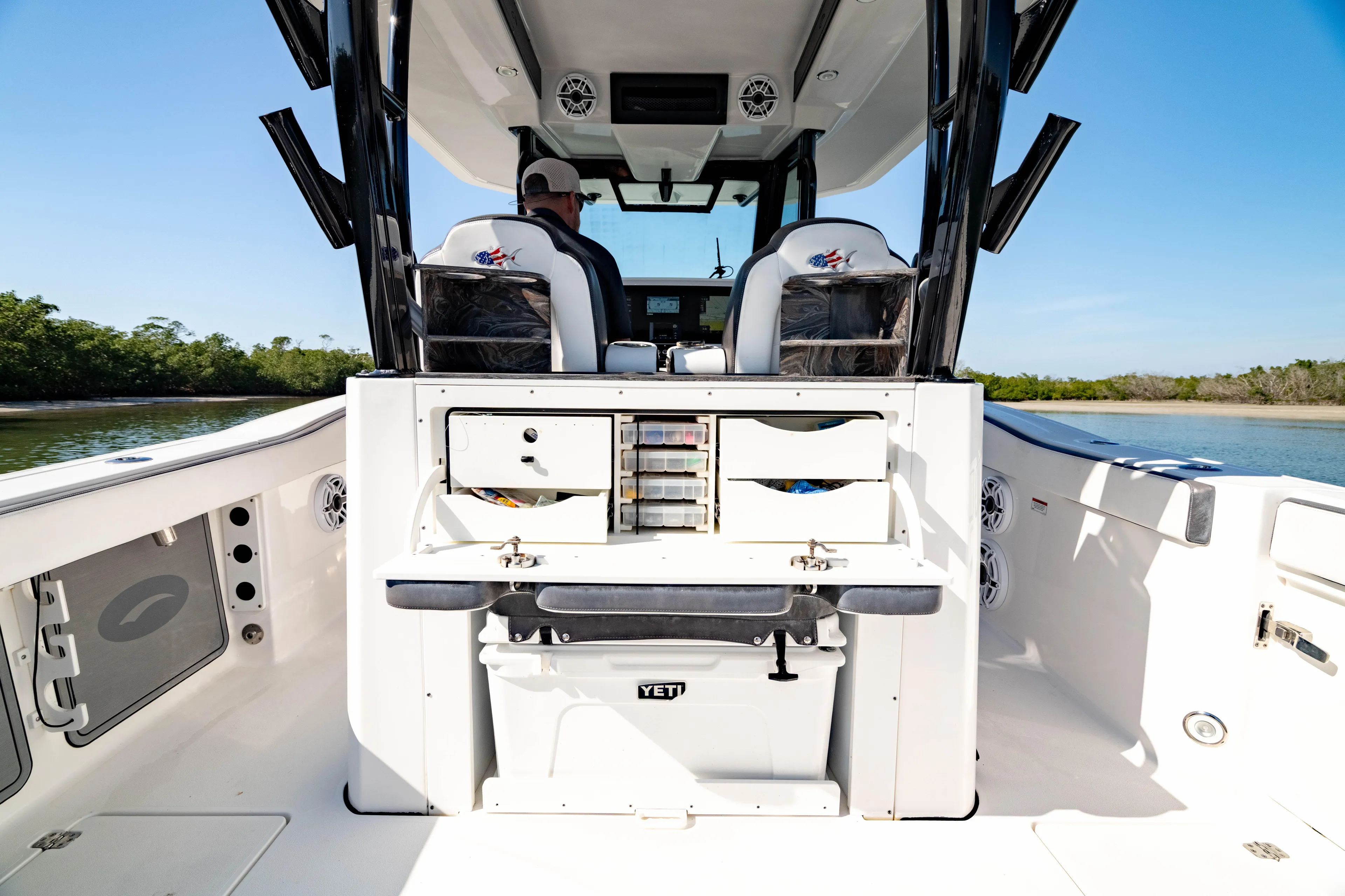  Yacht Photos Pics 2022 Crevalle 33 CSF boat interior with storage and seating, on calm water.