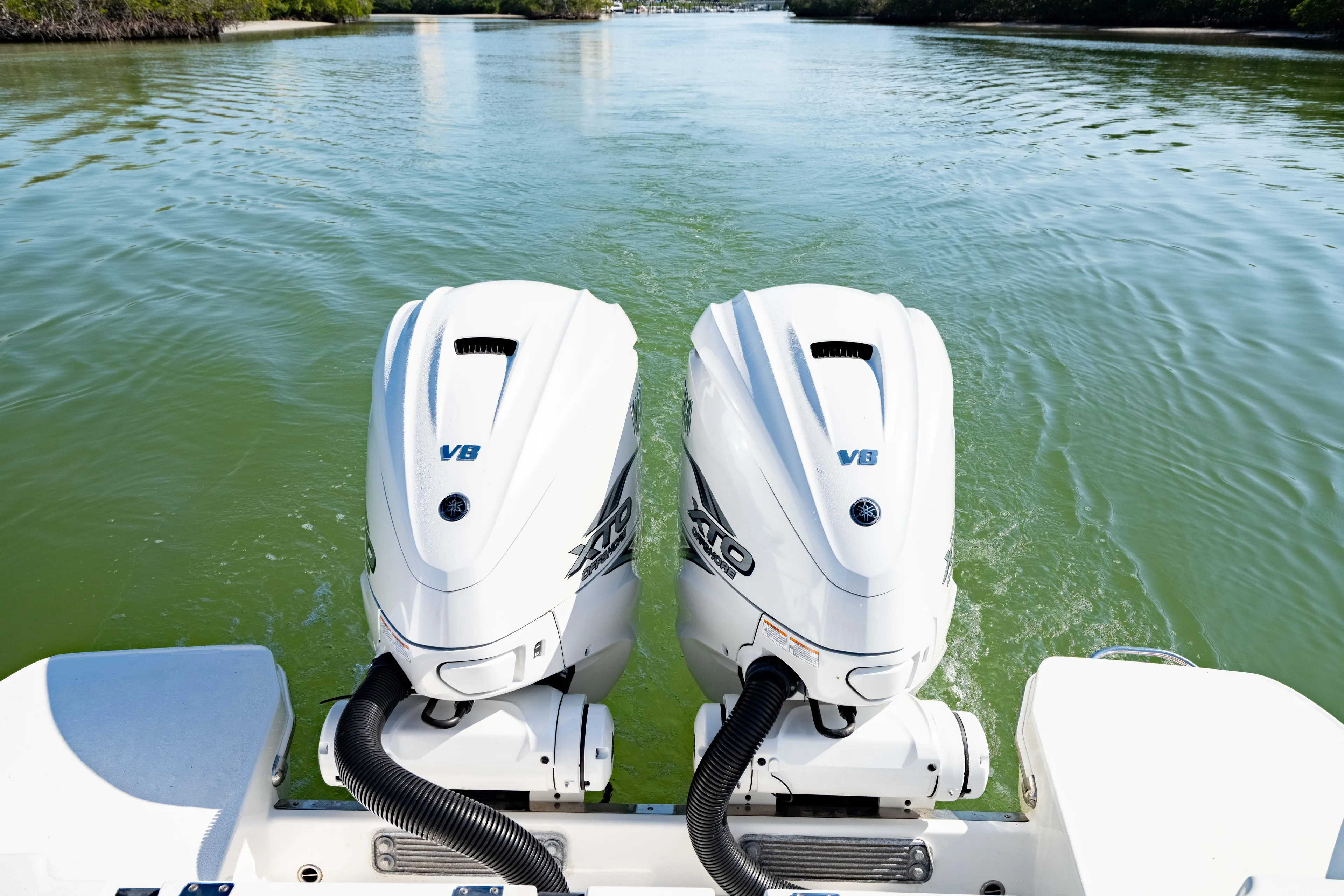  Yacht Photos Pics 2022 Crevalle 33 CSF boat with twin V8 outboard engines on calm water.