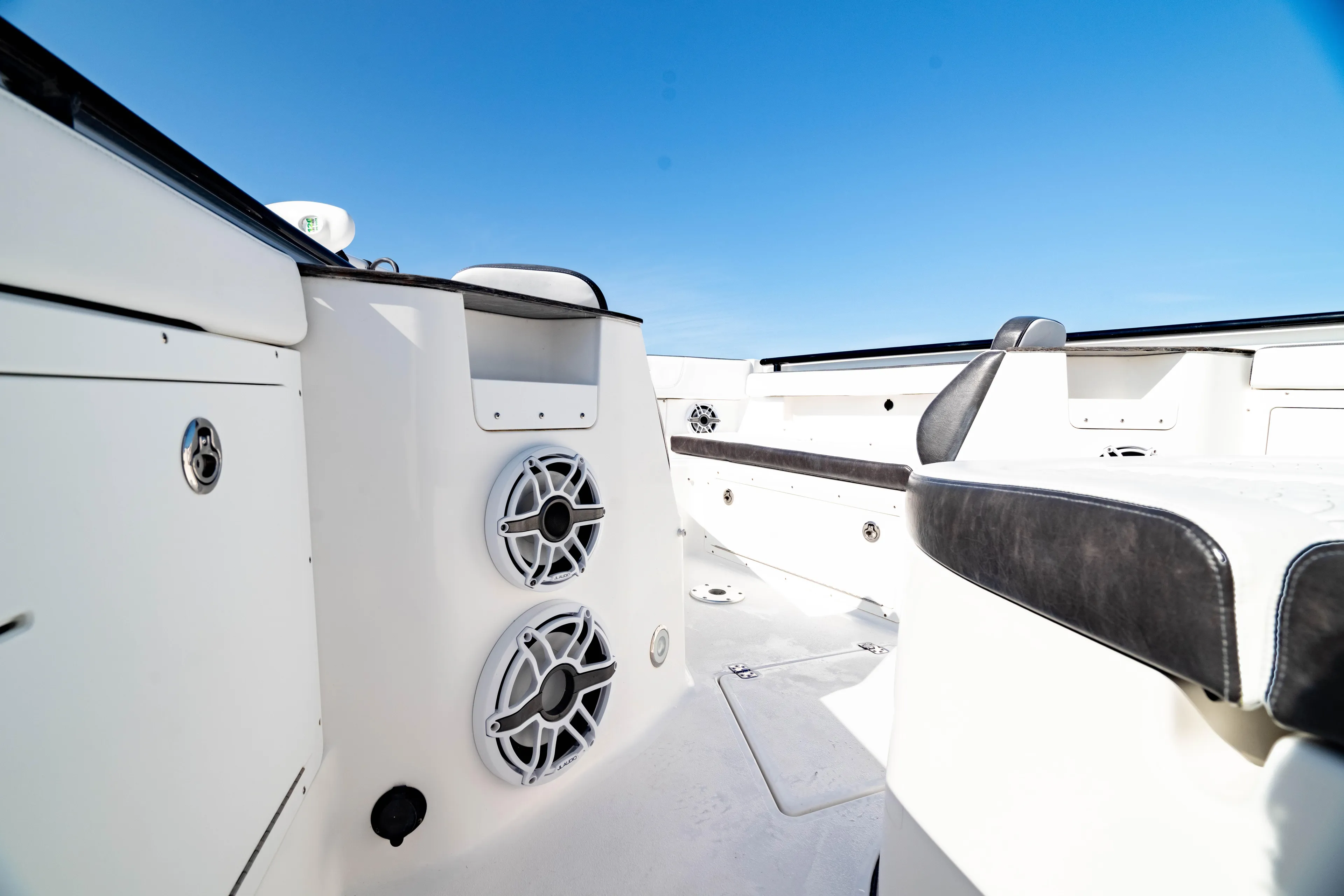  Yacht Photos Pics 2022 Crevalle 33 CSF boat interior with speakers and seating under clear blue sky.