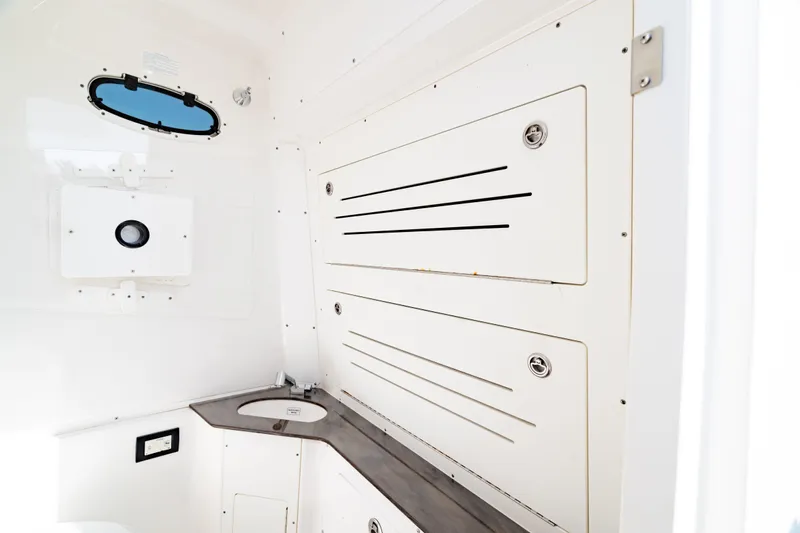  Yacht Photos Pics 2022 Crevalle 33 CSF boat interior with storage compartments and sink.