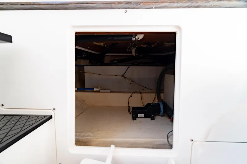  Yacht Photos Pics 2022 Crevalle 33 CSF boat storage compartment with visible wiring and equipment.
