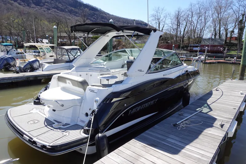  Yacht Photos Pics 2018 Monterey 295 Sport Yacht docked, featuring sleek design and spacious deck.