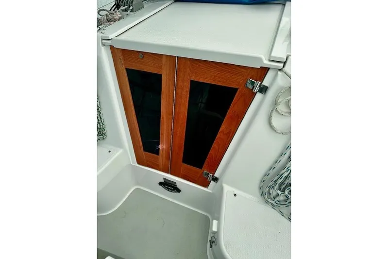  Yacht Photos Pics 2015 Catalina 315 sailboat cabin doors with wooden finish and nautical ropes.