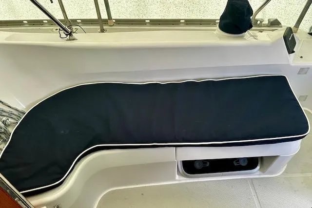  Yacht Photos Pics 2015 Catalina 315 boat interior with cushioned seating and storage compartment.