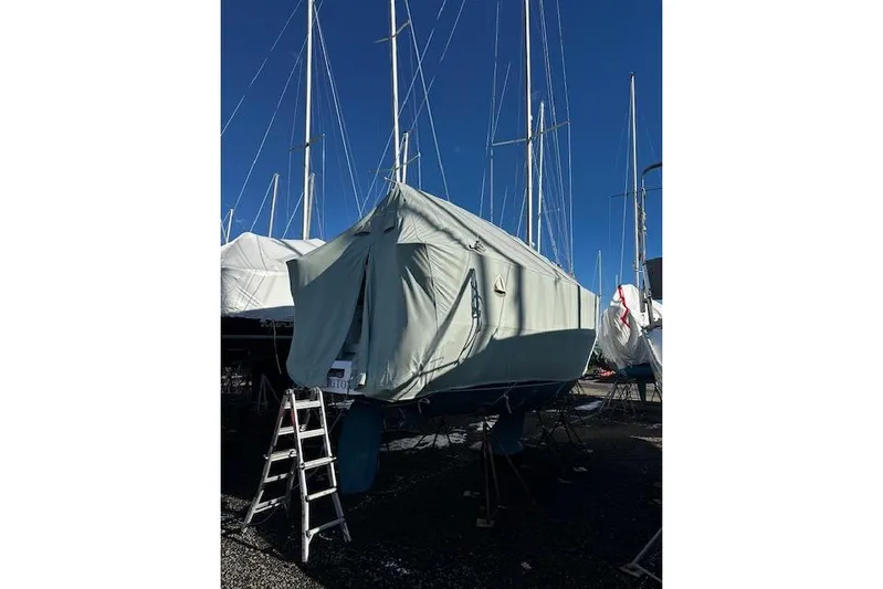  Yacht Photos Pics 2015 Catalina 315 sailboat covered, with ladder, in a marina under clear blue sky.