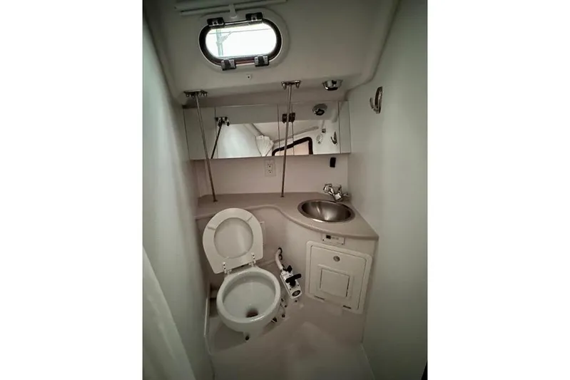  Yacht Photos Pics Compact bathroom in a 2015 Catalina 315 sailboat with toilet, sink, and mirror.