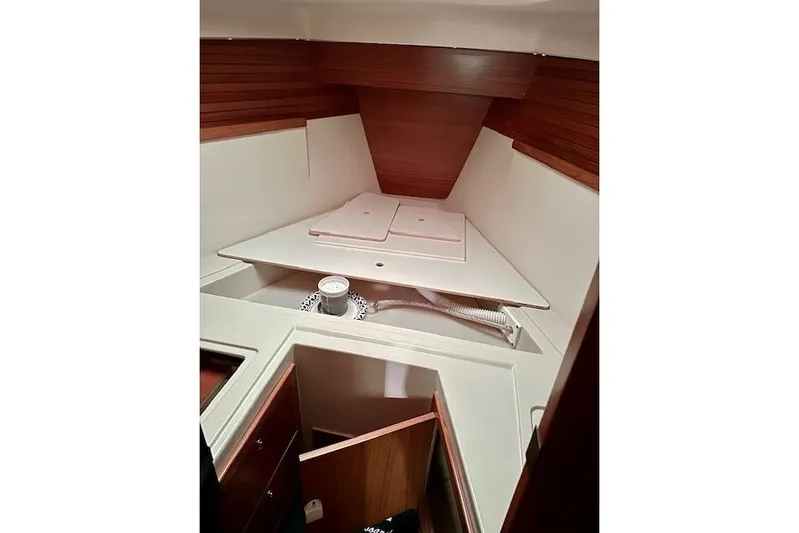  Yacht Photos Pics Interior cabin of a 2015 Catalina 315 sailboat, featuring wooden paneling and storage space.
