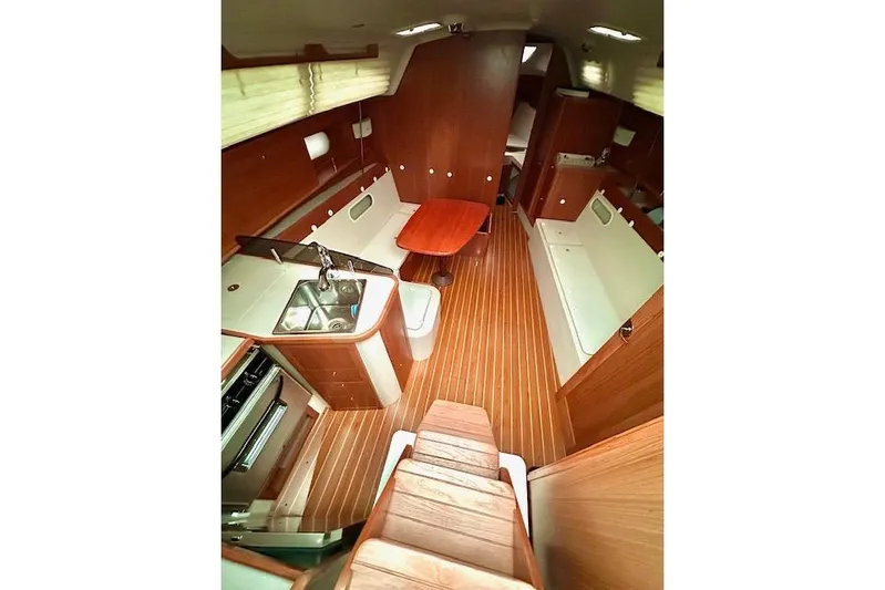  Yacht Photos Pics Interior of 2015 Catalina 315 sailboat with wood finish and compact kitchen.