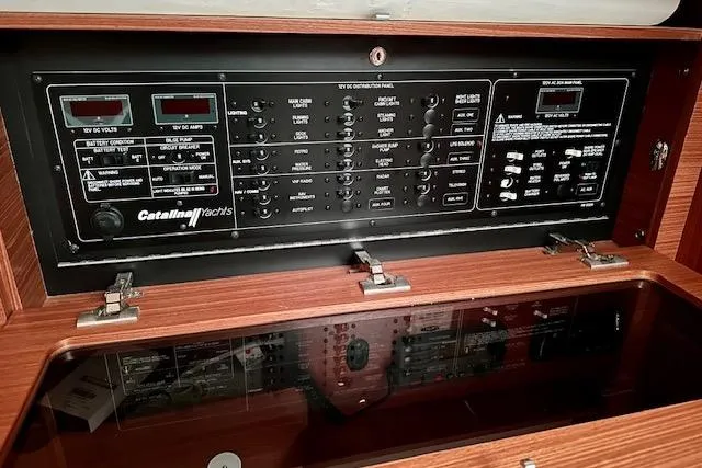  Yacht Photos Pics Electrical control panel of a 2015 Catalina 315 yacht, featuring various switches and meters.