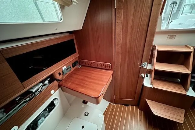  Yacht Photos Pics Interior of 2015 Catalina 315 sailboat with wooden cabinetry and foldable table.