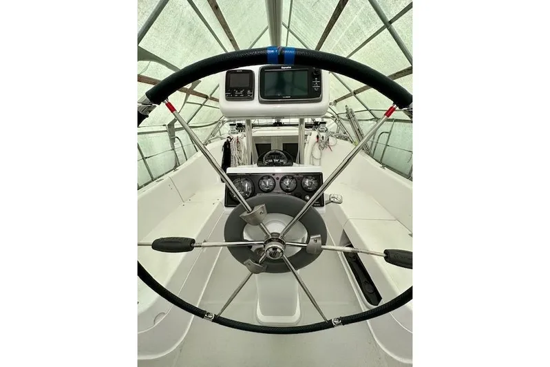  Yacht Photos Pics Steering wheel and dashboard of a 2015 Catalina 315 sailboat under a canopy.