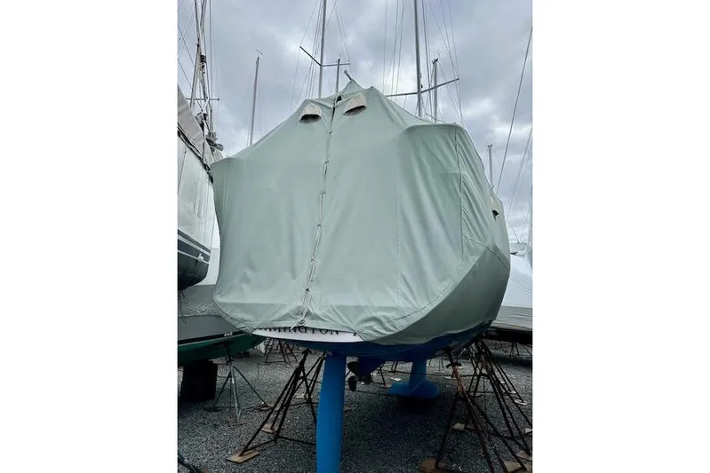  Yacht Photos Pics Covered 2015 Catalina 315 sailboat on stands under cloudy sky.