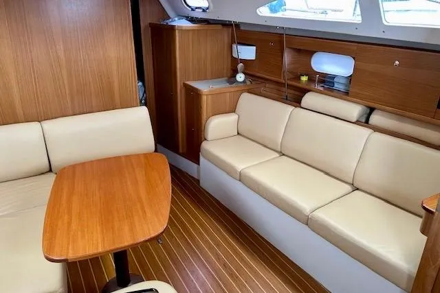  Yacht Photos Pics Interior of 2015 Catalina 315 sailboat with beige seating and wooden accents.