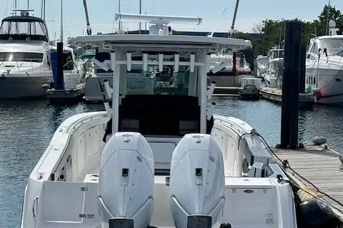  Yacht Photos Pics 2025 Crevalle 33 CTF boat docked in marina, featuring dual outboard engines.