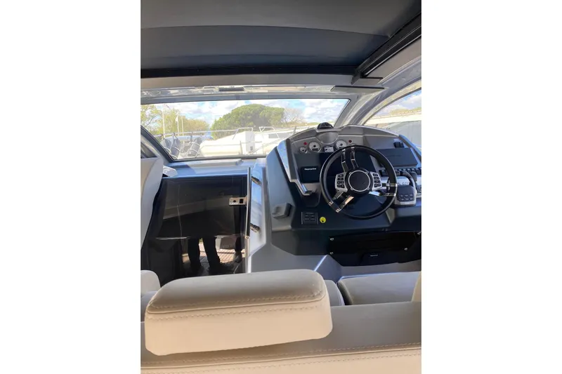  Yacht Photos Pics Interior view of 2020 Cranchi M 44 HT yacht cockpit with steering wheel and controls.