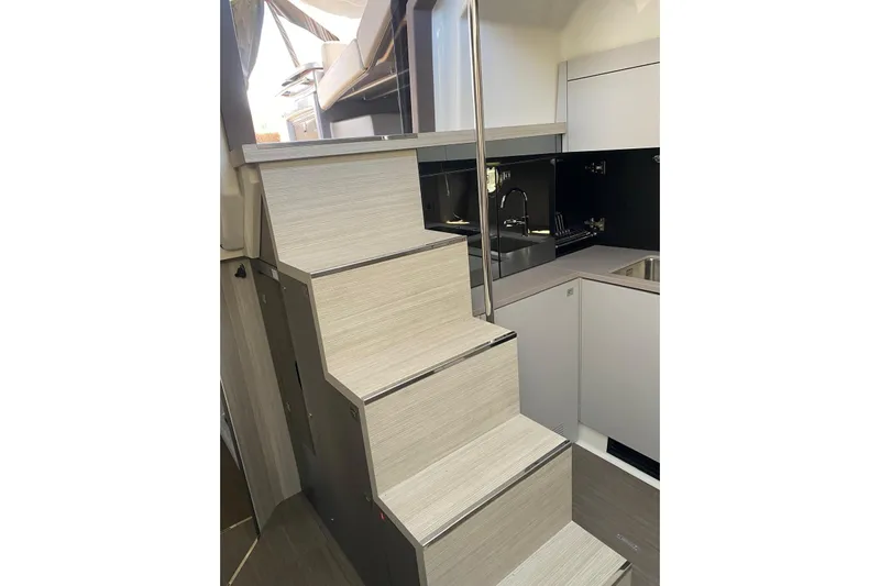  Yacht Photos Pics Modern interior of 2020 Cranchi M 44 HT yacht with sleek staircase and kitchen area.