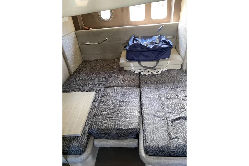  Yacht Photos Pics Interior cabin of 2020 Cranchi M 44 HT yacht with patterned bedding and a blue bag.