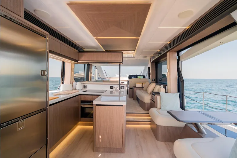  Yacht Photos Pics Luxurious interior of 2025 Galeon 560 Fly yacht with modern kitchen and seating area.