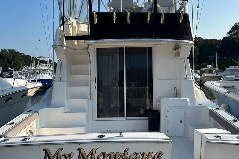  Yacht Photos Pics 2002 Silverton 42 Convertible yacht docked, featuring spacious deck and elegant design.