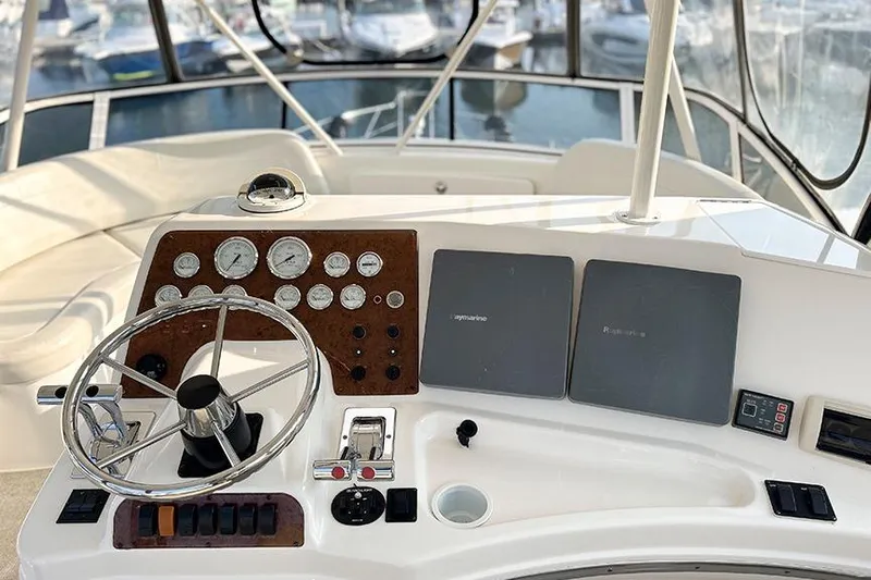  Yacht Photos Pics Helm of 2002 Silverton 42 Convertible yacht with gauges and controls.