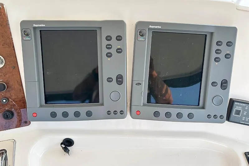  Yacht Photos Pics Raymarine navigation displays on a 2002 Silverton 42 Convertible yacht dashboard.