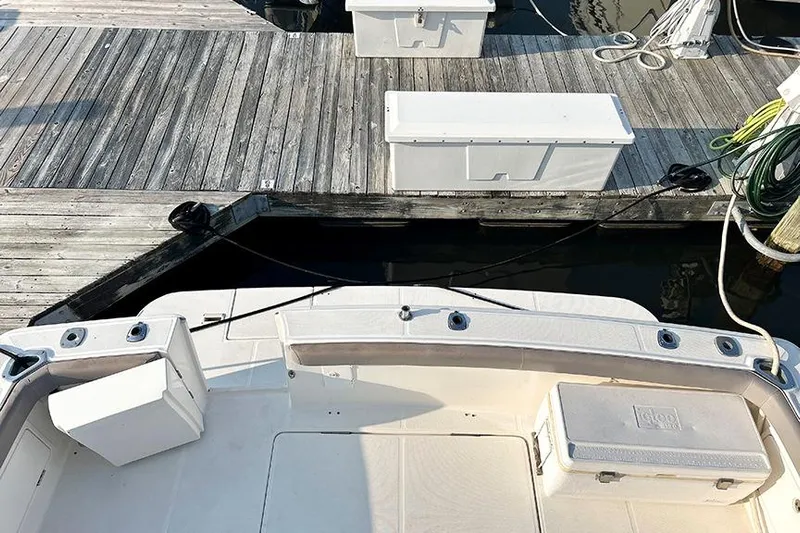  Yacht Photos Pics 2002 Silverton 42 Convertible boat docked, featuring deck and storage compartments.