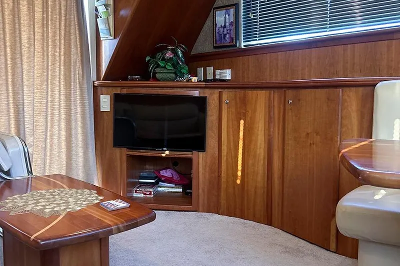  Yacht Photos Pics Luxurious interior of 2002 Silverton 42 Convertible yacht with wood paneling and modern amenities.