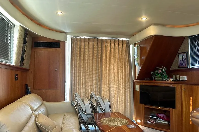  Yacht Photos Pics Interior of 2002 Silverton 42 Convertible yacht with beige sofa and wooden cabinetry.