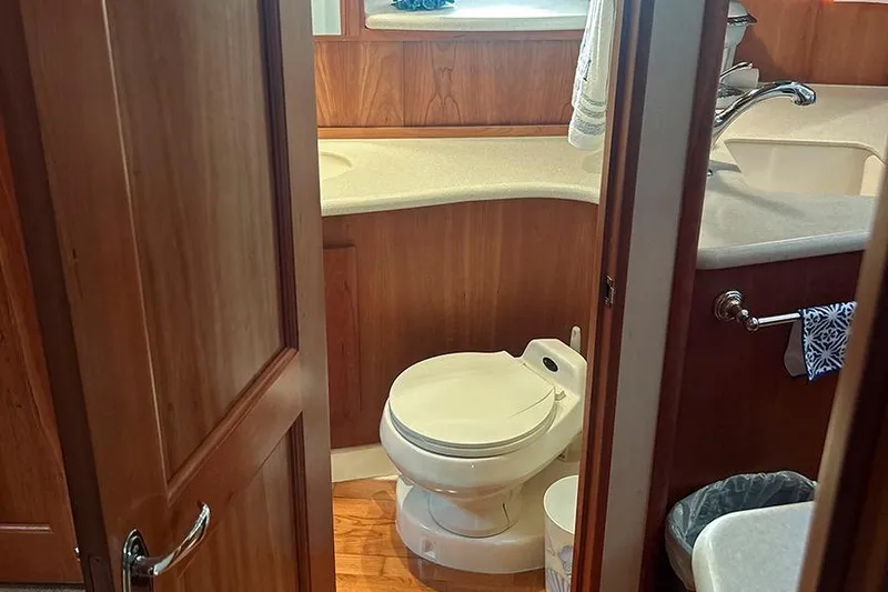  Yacht Photos Pics Bathroom interior of 2002 Silverton 42 Convertible yacht with wooden cabinetry.