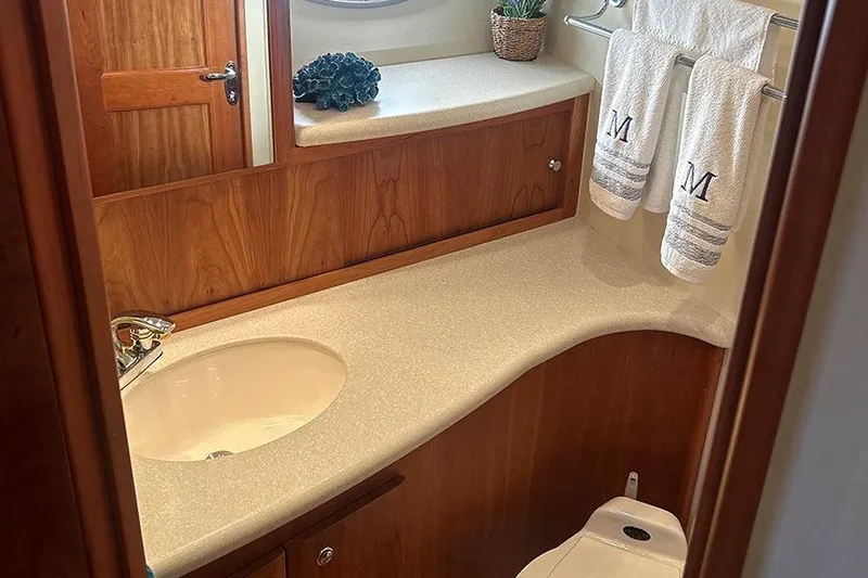  Yacht Photos Pics Luxurious bathroom in 2002 Silverton 42 Convertible yacht with elegant wood cabinetry.