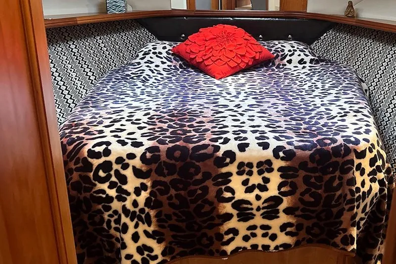  Yacht Photos Pics Cozy bedroom in 2002 Silverton 42 Convertible with leopard print bedding and red pillow.