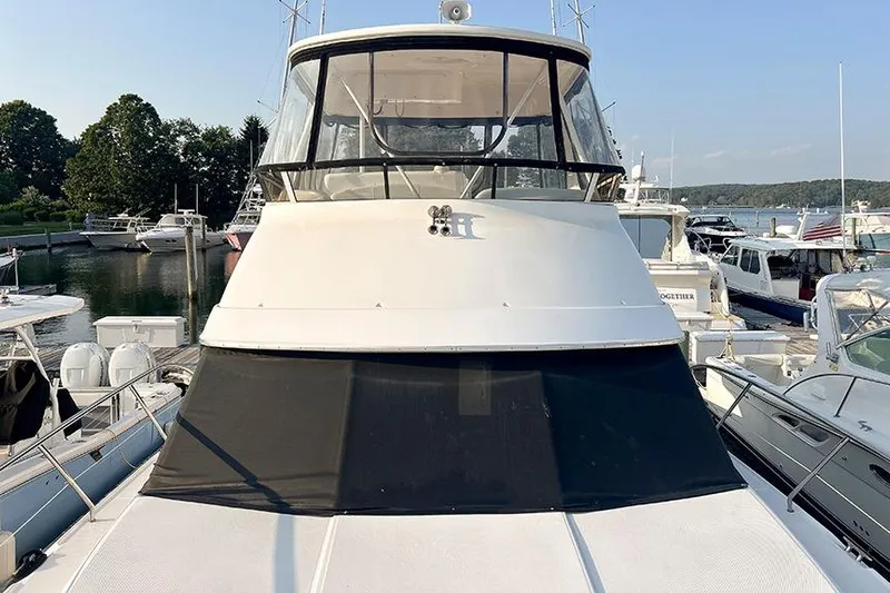  Yacht Photos Pics 2002 Silverton 42 Convertible yacht docked at marina, front view.