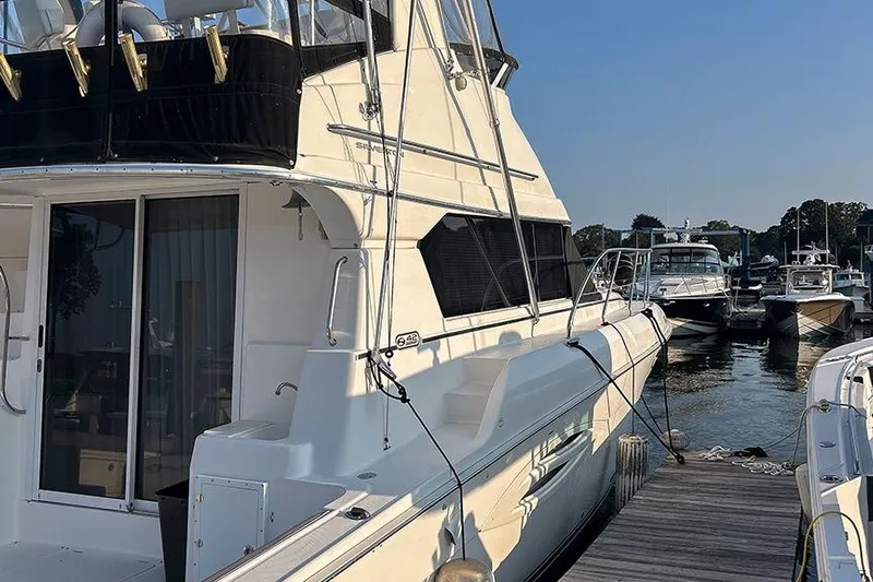  Yacht Photos Pics 2002 Silverton 42 Convertible yacht docked at marina, side view with clear sky.