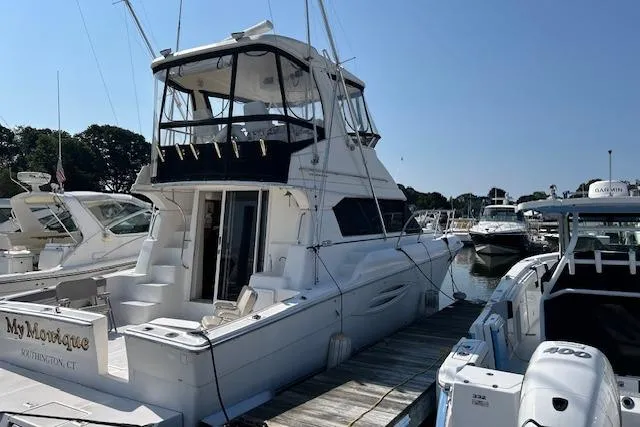  Yacht Photos Pics 2002 Silverton 42 Convertible yacht docked at marina, rear view.
