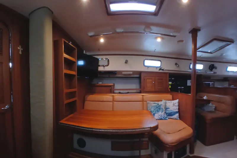 Nowhere To Be Yacht Photos Pics Interior of 2006 Island Packet 440 yacht with cozy seating and wooden furnishings.