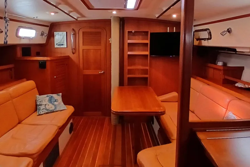 Nowhere To Be Yacht Photos Pics Interior of 2006 Island Packet 440 yacht with wooden furnishings and cozy seating.