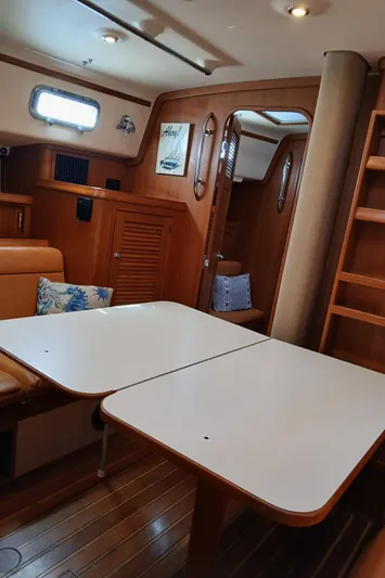 Nowhere To Be Yacht Photos Pics Interior of 2006 Island Packet 440 sailboat with dining area and wooden cabinetry.