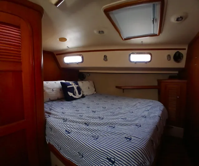 Nowhere To Be Yacht Photos Pics Cozy cabin interior of 2006 Island Packet 440 sailboat with nautical-themed bedding.