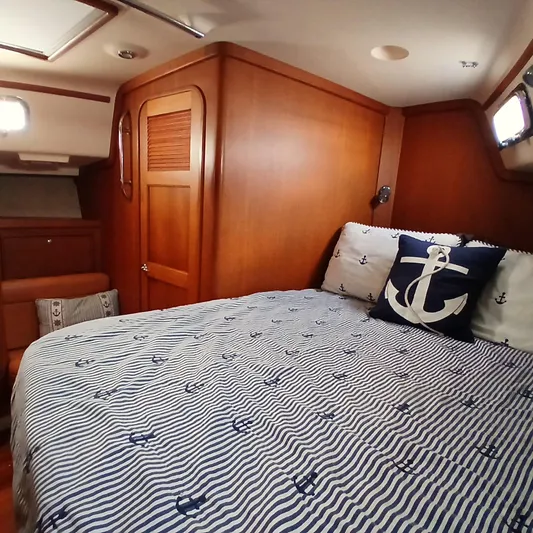 Nowhere To Be Yacht Photos Pics Cozy cabin interior of 2006 Island Packet 440 yacht with nautical-themed bedding.