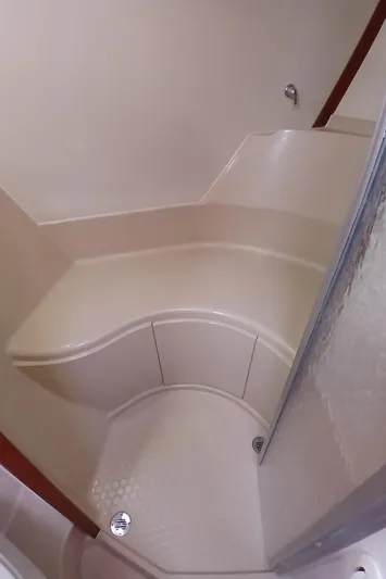 Nowhere To Be Yacht Photos Pics 2006 Island Packet 440 yacht interior shower with curved seating and modern design.