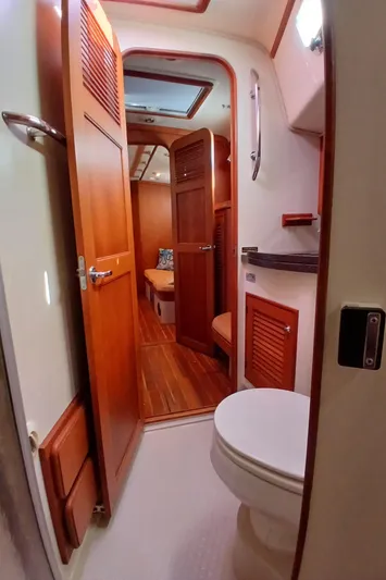 Nowhere To Be Yacht Photos Pics 2006 Island Packet 440 yacht interior, featuring a compact bathroom with wooden accents.