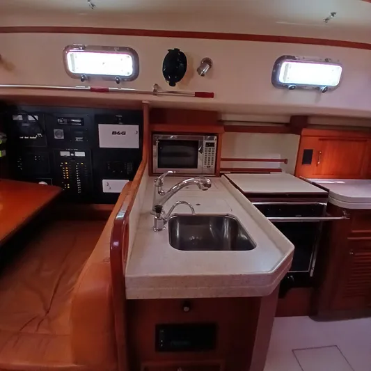 Nowhere To Be Yacht Photos Pics Interior of 2006 Island Packet 440 yacht showing kitchen area with sink and appliances.