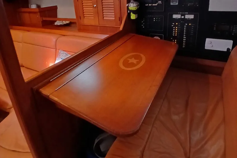 Nowhere To Be Yacht Photos Pics 2006 Island Packet 440 interior with wooden table and control panel.