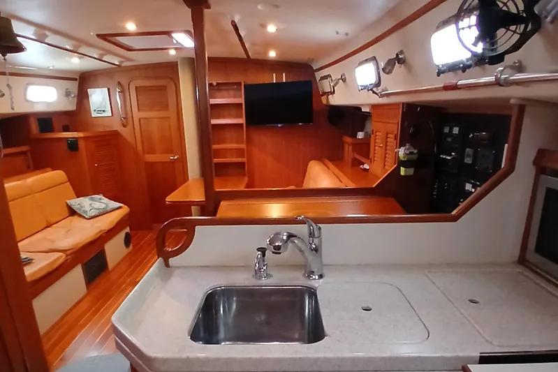 Nowhere To Be Yacht Photos Pics Interior of 2006 Island Packet 440 yacht with kitchen and seating area.