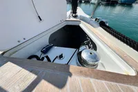 Anchor locker of 2023 Solaris 50 yacht with winch and chain, docked at marina.