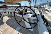2023 Solaris 50 yacht cockpit with steering wheel and navigation controls.