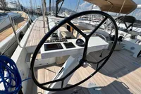 2023 Solaris 50 yacht cockpit with steering wheel and navigation controls.