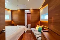 Luxurious 2023 Solaris 50 yacht cabin with wood interior and cozy seating area.