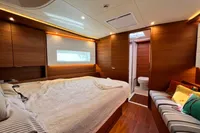 Luxurious interior of 2023 Solaris 50 yacht with cozy bedroom and modern bathroom.