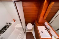 Modern bathroom in 2023 Solaris 50 yacht with wood accents and sleek fixtures.